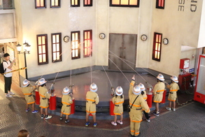 Children challenged themselves in firefighting activities as firefighters